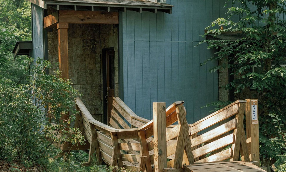 Mill Spring House | Romantic treehouse nestled on the creek, private deck, loft bedroom, shower skylights, bridge, sleeps 3.