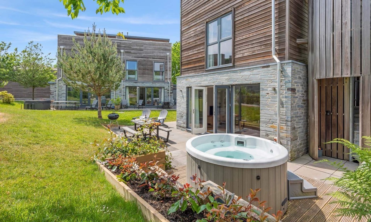 Talland House | Stylish and contemporary pet friendly property featuring a wood-burning stove, patio hot tub and lar
