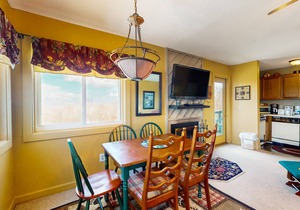 Mountain-view condo with hot tub, pool, high-speed WiFi & wood-burning fireplace