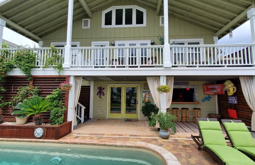 Ocean Isle Beach House | Charming Coastal Cottage On A Canal with Private Heated Pool, Tiki Bar and Dock