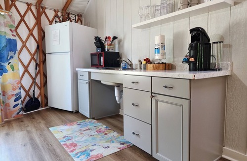 Mill Spring House | 30' ADA Yurt with a large deck, on the creek, full kitchen, dome skylight, dog friendly, 2 bedrooms, sleeps 5.