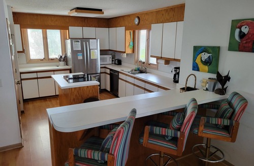 Ocean Isle Beach House | 4bd Canal Front home with an Elevator, dock, fenced back yard, 2 master suites
