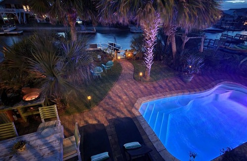 Ocean Isle Beach House | Charming Coastal Cottage On A Canal with Private Heated Pool, Tiki Bar and Dock