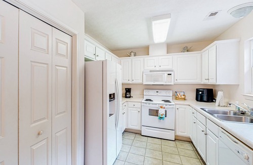 Southport House | Charming dog-friendly home with pool access, screened patio, cozy deck & W/D
