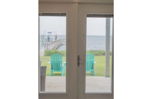 Harkers Island Resort | Cozy waterfront retreat with lighthouse view.