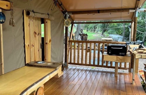 Hillsville RV Rental | Creekfront Safari Tent with Outdoor Bath and Deck in Virginia