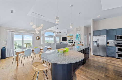 Salvo House | Dazzling waterfront home with balconies, private pool, hot tub, & game room