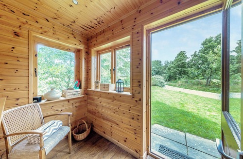 Menai Bridge Ski Chalet | Ground floor: Spacious open plan lounge, kitchen, dining area with log burner.