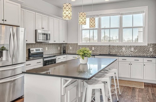East Hill House | Modern Townhome with Curated local art, Rooftop, Tiki Lounge
