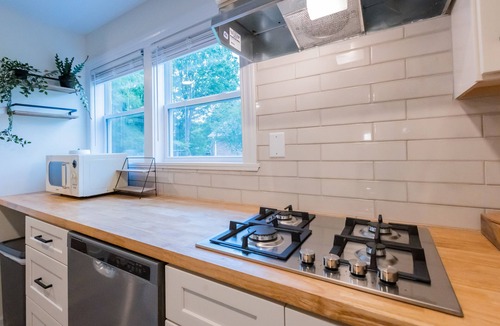 Sunset Road Cottage | Stylish renovated cozy cottage studio in quiet neighborhood 10 minutes to Uptown