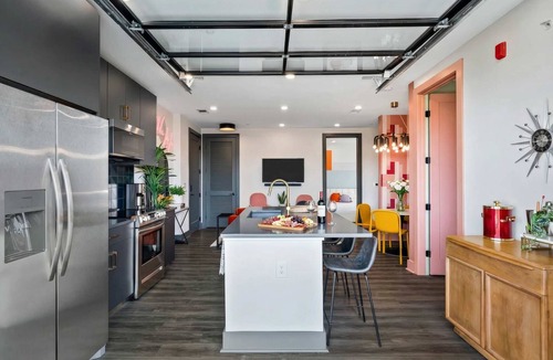 Rolling Mill Hill Apartment | Summer rooftop deck, skyline views, garage-door kitchen near Broadway