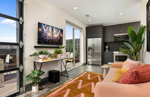 Rolling Mill Hill Apartment | Summer rooftop deck, skyline views, glass garage door near Broadway