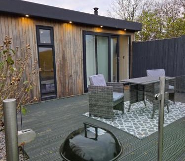 Amroth Apartment | The Den - Modern cabin with wood burning stove