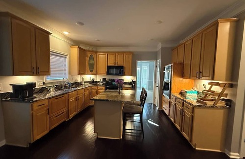 Greensboro House | Welcome to The Clovelly, a spacious 2-story vacation home that blends charm with modern comfort. Perfect for families, friends, or groups, this cozy retreat features inviting living spaces, a fully equipped modern kitchen & comfortable bedrooms.