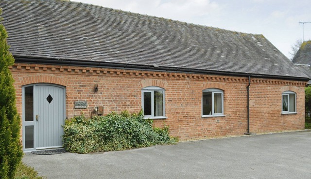One of two barn conversions with exposed beams and trusses.