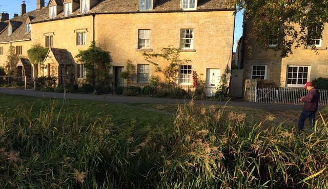 Period cottage in idyllic riverside location in prime Cotswolds village