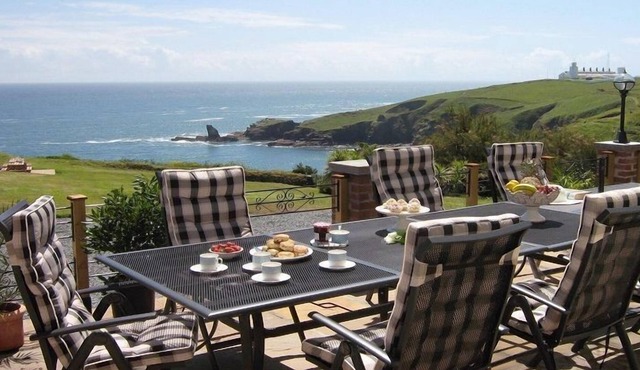 This fabulous Arts and Crafts villa sits in an acre of grounds on a front line cliff top